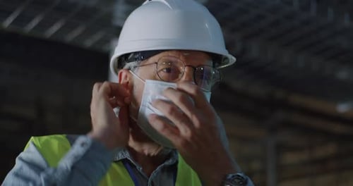 Adult Wearing Safety Mask and Hard Hat
