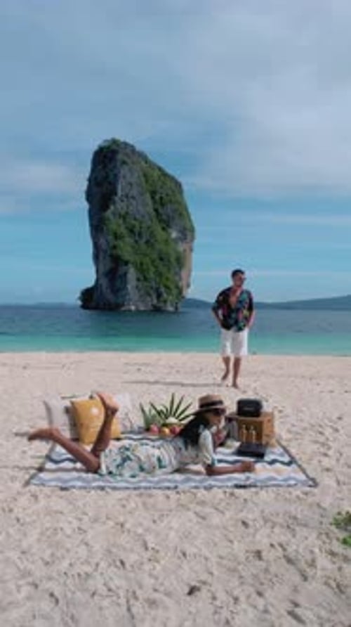 Caucasian Men and Asian Women Having a Picnic on the Beach of Koh Poda Island Krabi Thailand