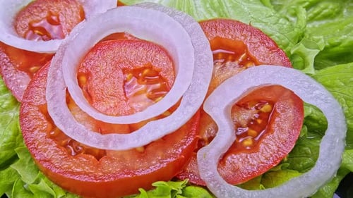 Fresh Sliced Tomatoes and Onions on Lettuce