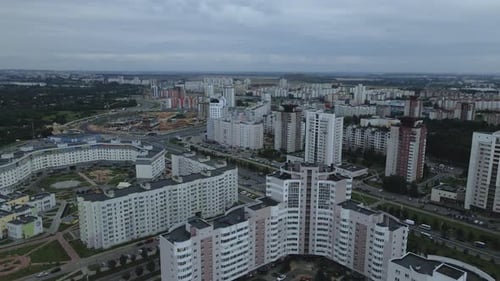 City block. Modern multi-storey buildings. Flying at dusk at sunset.