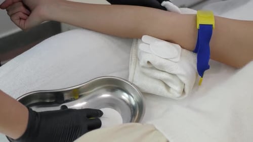 Medical Professional Cleaning Patient Arm