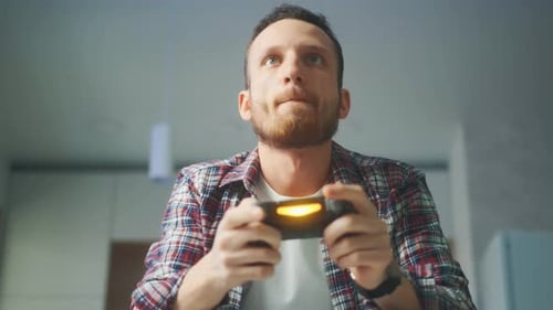 Excited Man Winning at Video Games at Home