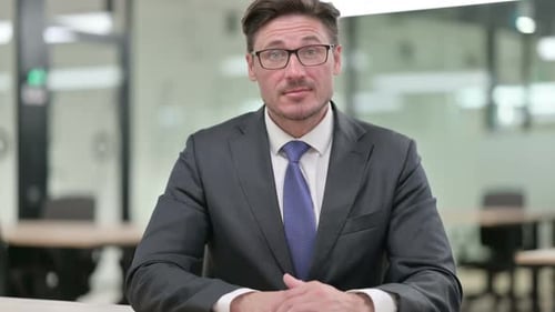 Confident Man Smiling in Office Setting