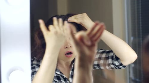 Shocked Woman Discovers Gray Hairs in Mirror