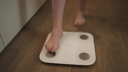 Person Stands on Digital Scale for Measurement