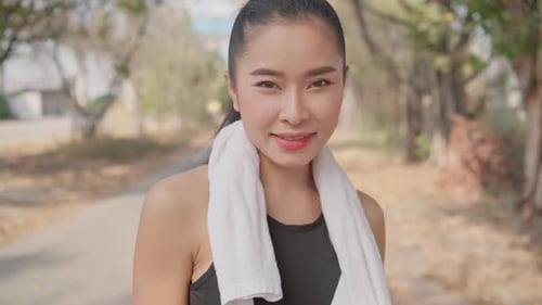 Smiling Young Woman with Towel Outdoors