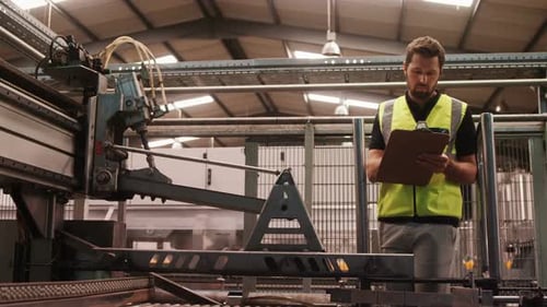 Engineer maintaining record in clipboard