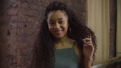 Smiling Woman with Curly Hair Posing