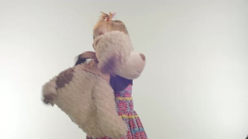 Child Holding Stuffed Animal Dog Smiling