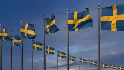 Waving Swedish Flags Against Blue Sky