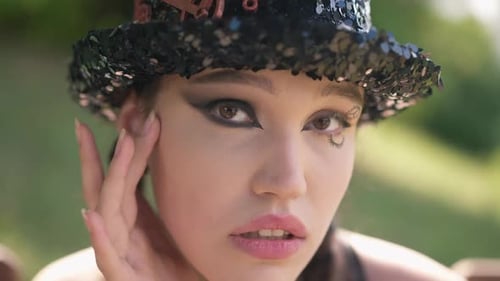 Young Woman Posing with Eye Makeup in Nature