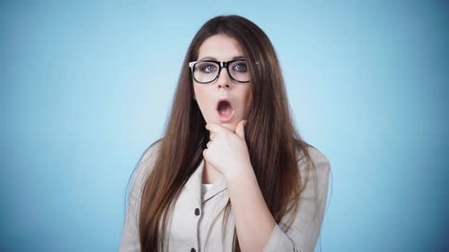 Surprised Woman with Brown Hair, Glasses, and Jacket