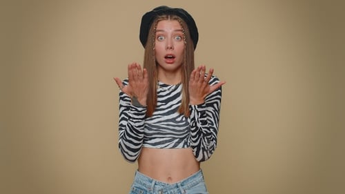 Playful Woman Expressing Shock and Amusement in Studio