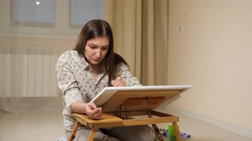 Young Woman Painting Art at Home on Canvas