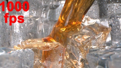 Brandy Whisky Splashing On Ice In A Glass In Slow Motion