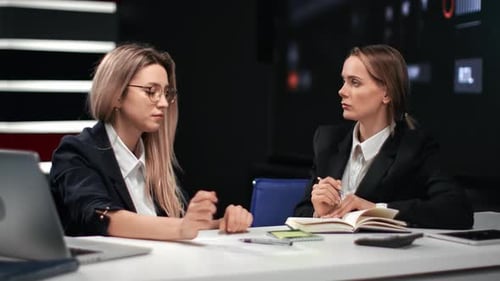 Two Woman Colleagues Discussing Job Analyzing Project at Business Meeting