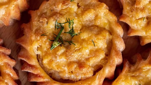 Hot Tasty Muffins with Vegetables and Cheese on Wooden Board