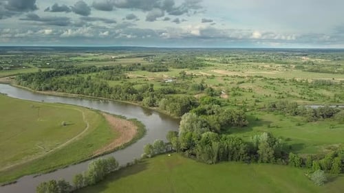 Flight Over Green Meadow and River in Spring