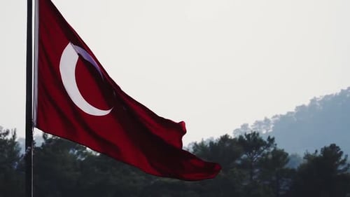 Turkish Flag Waves Against A Soft White Sky