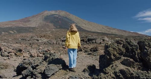 Female Traveller Looking at Volcanic Rocky Landscape Against Teide Mountain