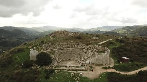 Drone view of the theatre in Segesta, Sicily, Italy, Pull back shot.