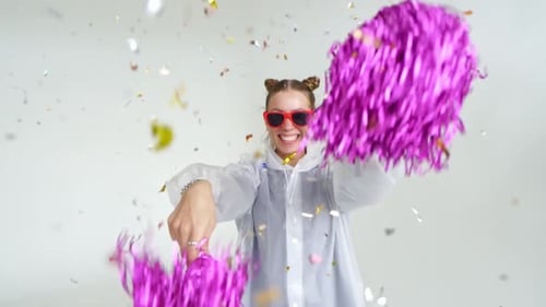 Smiling Woman Dancing with Pom Poms and Confetti