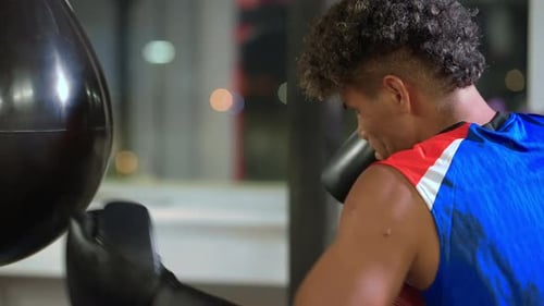 Man Boxing Heavy Bag in Gym Training