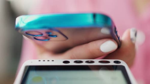 Woman Pays for Purchase Using Mobile Phone By Bank Transfer
