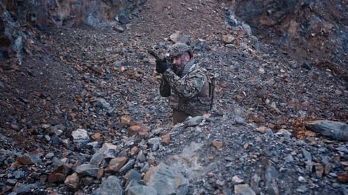 Special Force Soldier Takes Aim in a Mountain Gorge