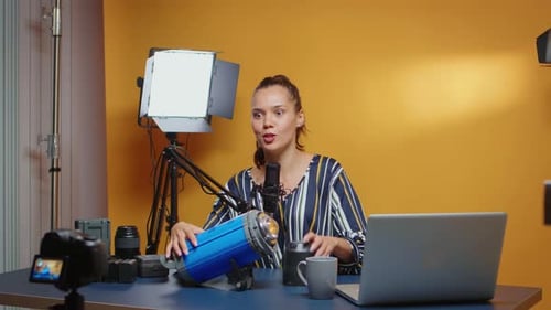 Woman Vlogging About Studio Light At Desk