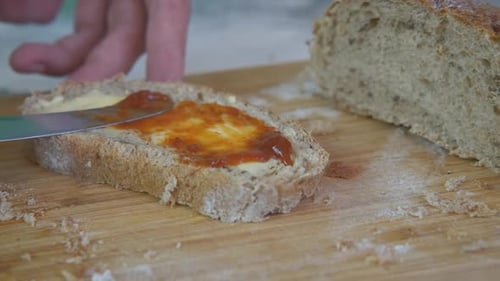 Buttered Bread Slice Topped with Delicious Orange Jam