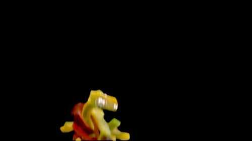 Sliced Peppers Falling on a Black Background