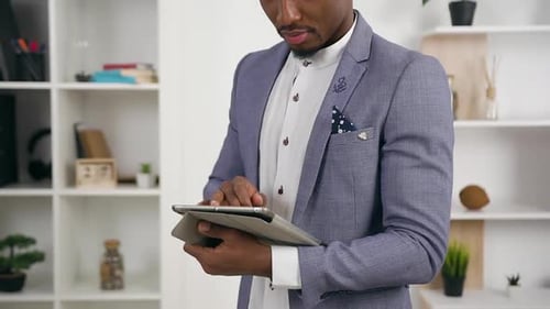 Young Male Office Manager which Working on i-pad in Office, Posing on Camera