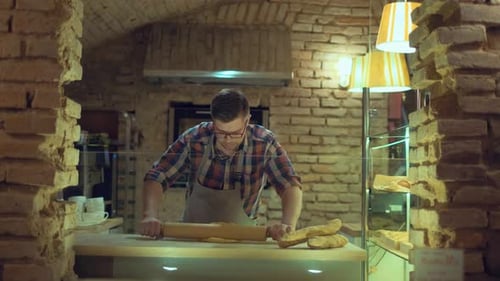 A Male Baker Is Kneading Dough and Making Bread with a Rolling pin.Cooking Process, Culinary, recipe