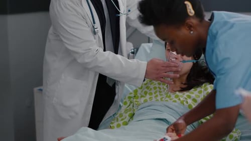 Clinical Team Monitoring Patient Putting Oxigen Mask Analyzing Respiratory Condition