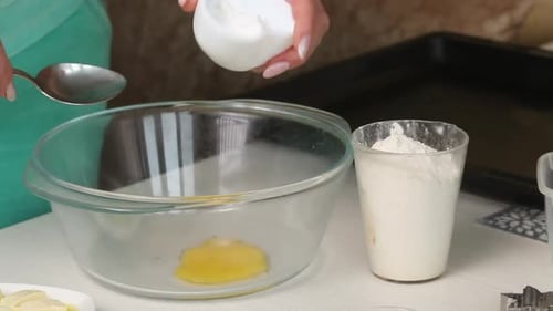 A Woman Mixes The Ingredients For Making A Biscuit In A Container.