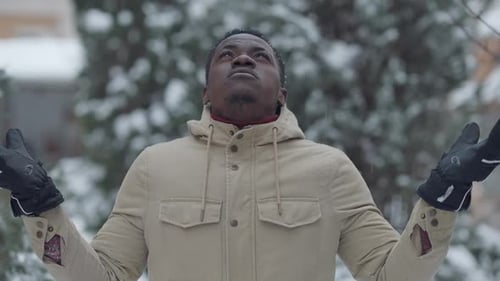 Man Enjoying Winter Snowfall Outdoors