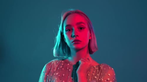 Blonde Woman Posing with Red and Turquoise Lighting