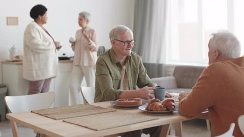 Adults Conversing at Home Over Breakfast