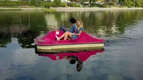 Cute Couple Enjoying A Boat Ride In The Park