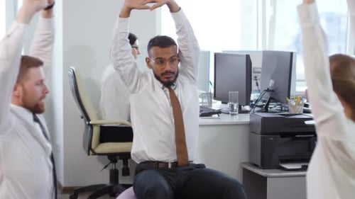 Office Workers Stretching on Exercise Balls for Wellness