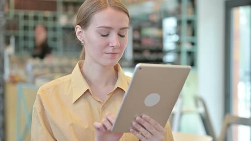 Young Adult Using Tablet Indoors