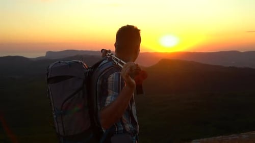 Hiker enjoying mountain view at Sunrise