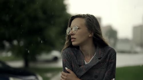 Young Businesswoman is Walking in the City While It is Raining