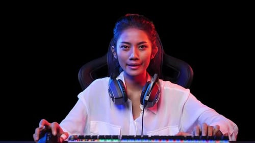 Young Woman Gaming at Computer with Expressions