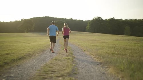 Couple Running Together on a Rural Path