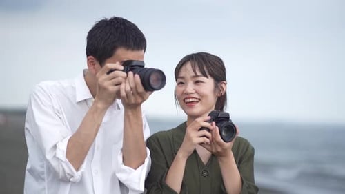 Couple Taking Pictures at the Beach Together