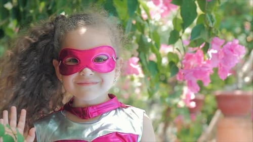 Cute Child Superhero in Garden Smiling