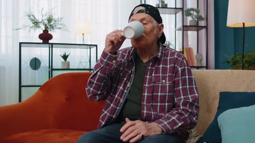 Senior Man Relaxing at Home with Drink