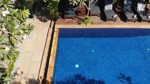 Slow Drone Tracking Shot Revealing a Tropical Hotel Grounds and Swimming Pool